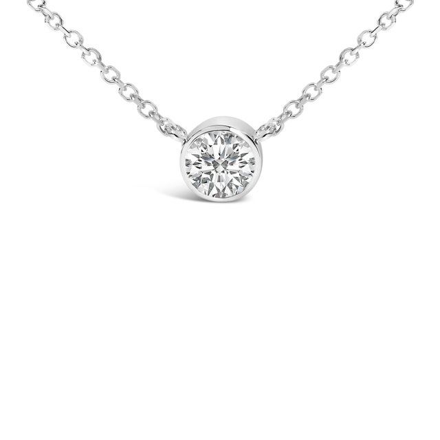 This 14K white gold pendant necklace, with its clean, minimalist design, exemplifies luxury and sophistication. Cradled in...