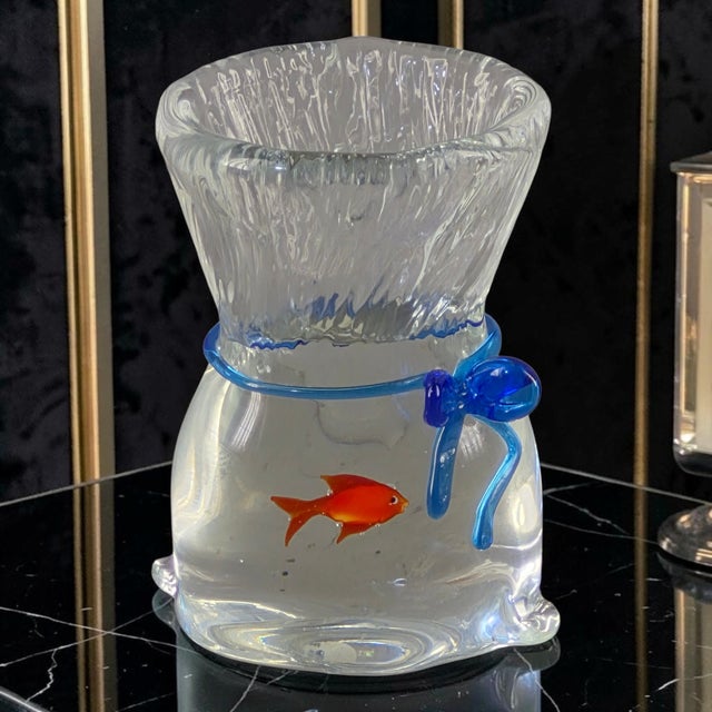 This vintage Murano glass paperweight features a unique fish design inside a hand-blown blue ribbon bag, created by...