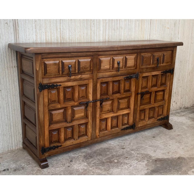 From Northern Spain, constructed of solid walnut, the rectangular top with molded edge atop a conforming case housing...