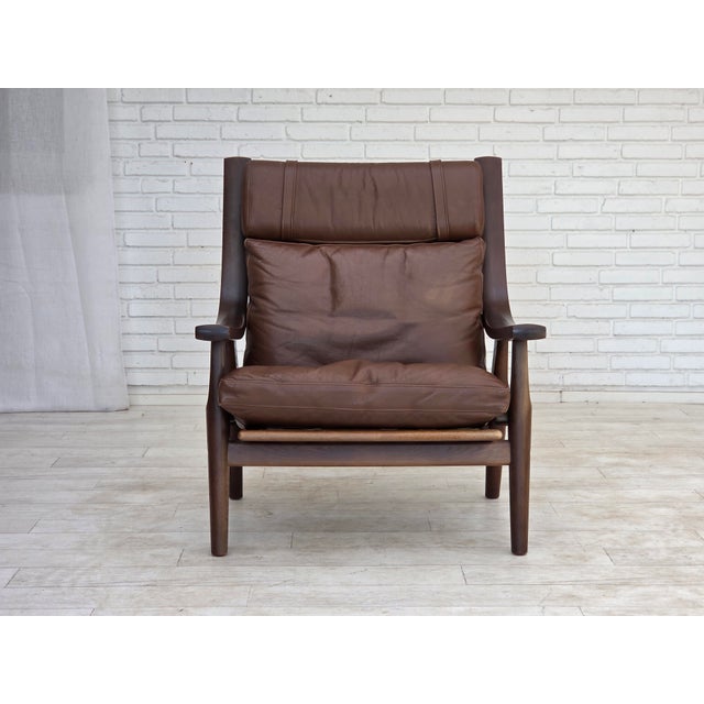 1970s, Danish design by H.J.Wegner. Highback armchair, model GE530. Brown furniture leather and dark oak wood. Original...