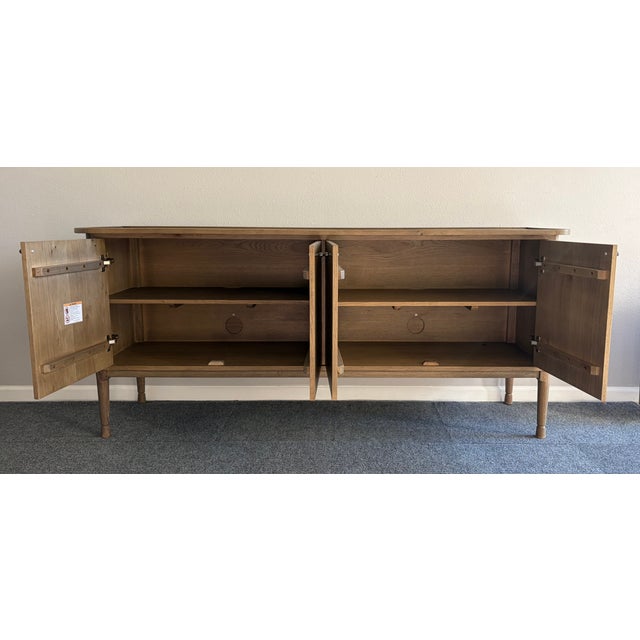 Crafted of oak, this beautiful sideboard is a truly versatile piece featuring tapered legs and an overhanging inset top...