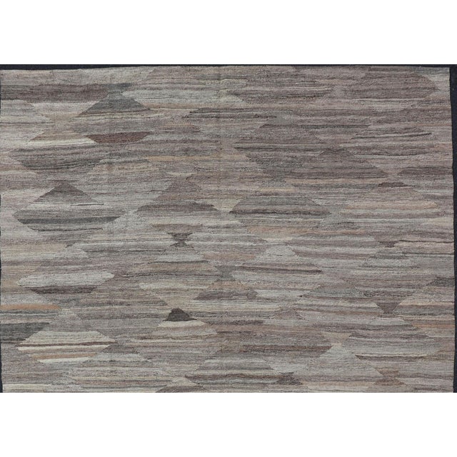 Modern and casual flat-woven Kilim rug. Neutrals, charcoal, gray, blue and brown Afghan Modern Kilim Geometric design....