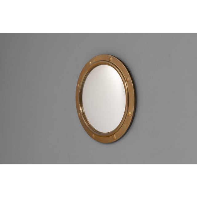 Brass framed circular porthole mirror with convex glass. Circa 1930