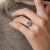 A graceful jewel from the 1960s, this Mid Century cluster ring centers on a luminous 2.20 carat round brilliant cut blue...