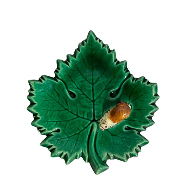 A charming vintage majolica decorative plate featuring a beautifully sculpted green leaf with deeply textured veining and...