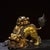 This impressive gilt bronze incense burner features a dynamic guardian lion in a playful yet protective pose. The lion is...