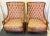Vintage pair of regency style high back chairs from the 1960's. Each has a solid fruitwood frame in a honey tone finish...