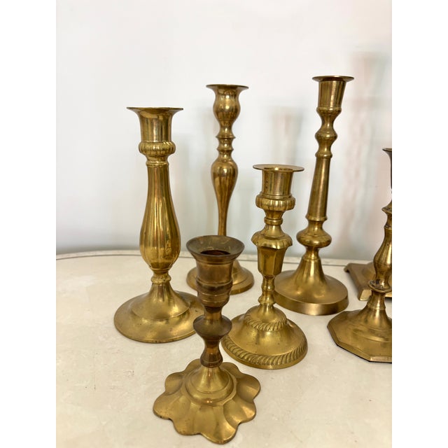 Assorted lot of 9 Traditional brass candlesticks. The heights range from 4.75”H to 12.25” tall. Ornate and classic in...