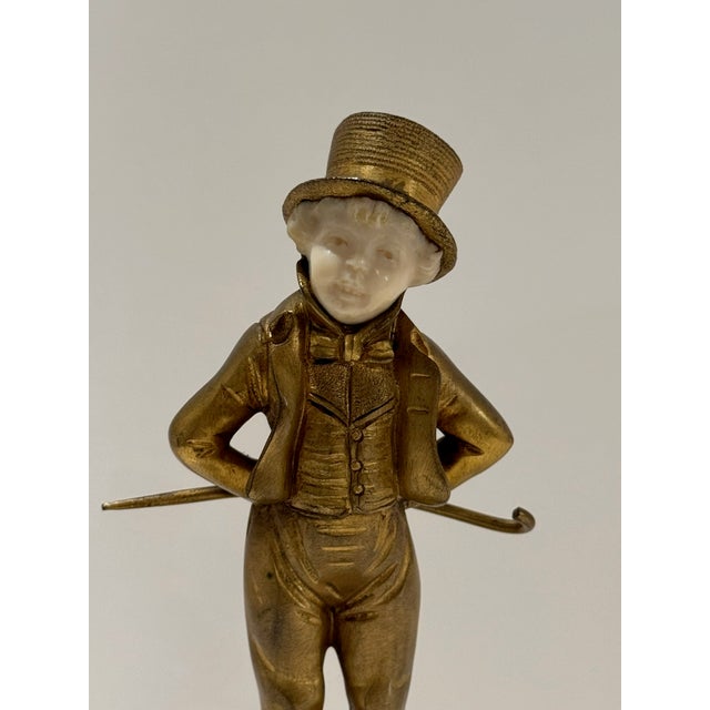 Exquisite figural sculpture by French artist Georges Omerth (active 1895–1925), depicting a jaunty young boy in a top hat...