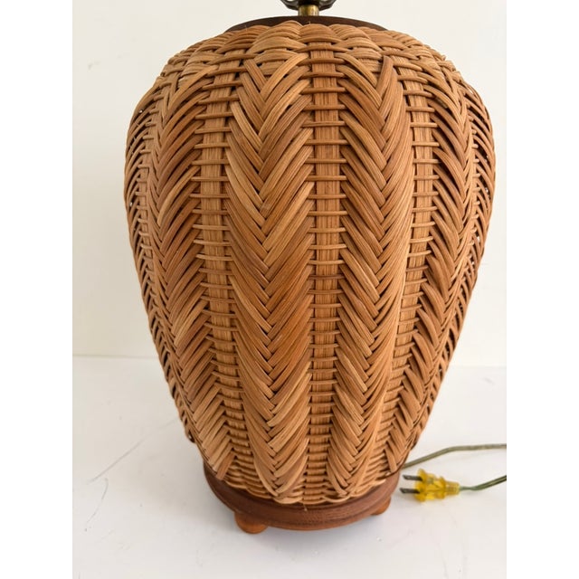 Vintage woven rattan table lamp with a sculptural urn form and deep, dimensional basket weave. Likely made in the 1970s,...