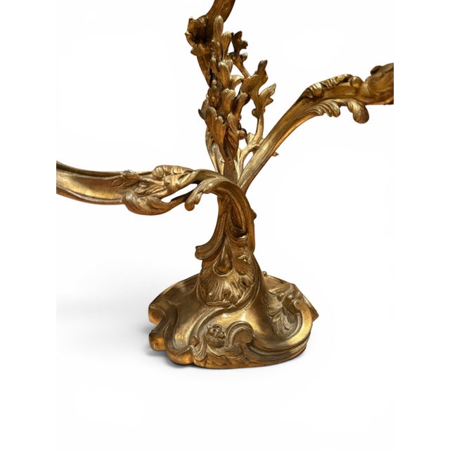 A pair of late 19th century French bronze three-light candelabra. Each candelabrum features three curved candle arms,...