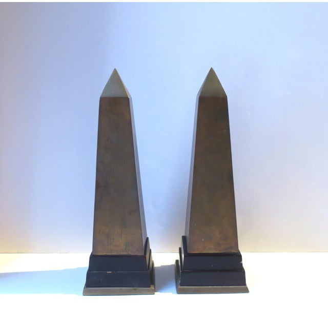 A pair of brass and wood Obelisks, in the Modern style, circa late-20th century. A great set of decorative objects,...