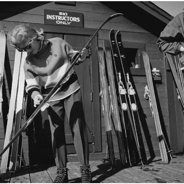 New England Skiing 1955 by Slim Aarons Slim Aarons Limited Estate Edition Skis leaning against the wall of a hut marked...