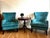 Elegant pair of teal velvet wingback accent chairs featuring a beautifully curved silhouette and classic nailhead trim....