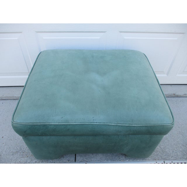 This mint green leather ottoman is by Hancock & Moore and features a hidden tray which extends up and outward with a knee...