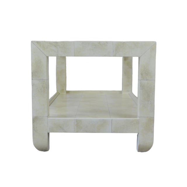 The Karl Springer style hand-painted coffee table in a simulated "Goatskin" finish is hand-painted into a patchwork...