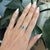 This elegant ring features a striking Topaz in a deep London Blue hue, cut in a refined 6x4mm emerald shape. Set in solid...