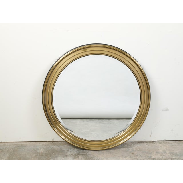 A French vintage brass round mirror from the mid 20th century, with beveled accents. Created in France during the...