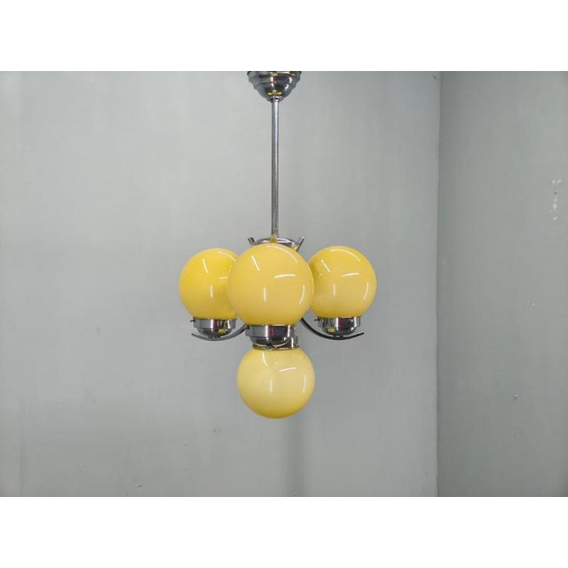 Beautiful Art Deco chandelier produced in Czechoslovakia during the 1930s. This elegant ceiling light features chrome...