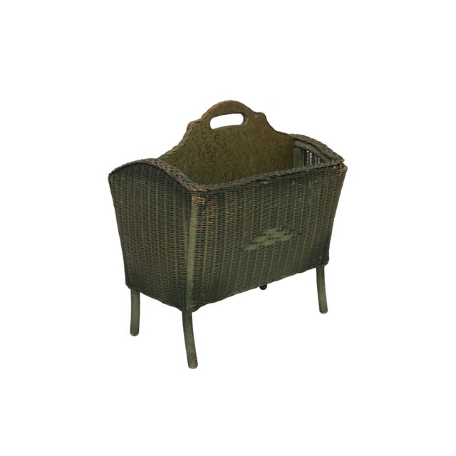 A 1920’s wicker newspaper and magazine rack made by Lloyd Loom of Menominee, Michigan. Decorated with an open wicker braid...
