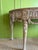 The table features a beautifully contoured, half-moon stone marble top with soft, natural veining that mirrors the curves...