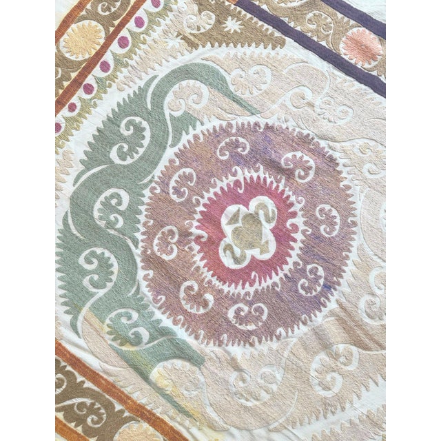 Hand-Embroidered Vintage Suzani from Uzbekistan, circa mid-1960s. There are stains on this suzani. Dimension; 50'' x 59''...