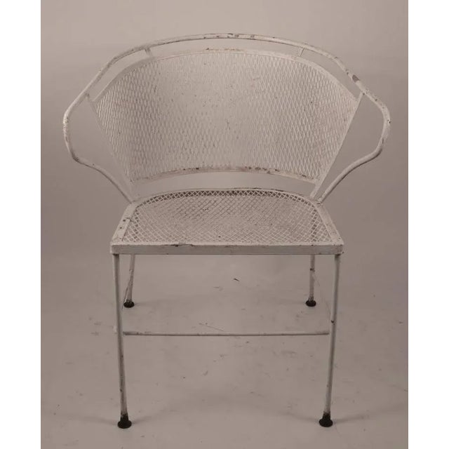 Nice pair of wrought iron and metal mesh outdoor patio, garden chairs, attributed to Woodard. Interesting wraparound back...