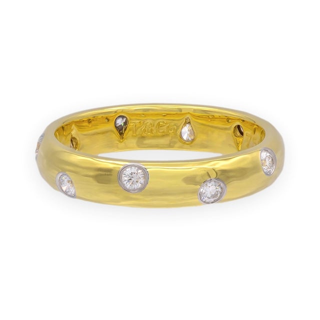 A beautifully crafted band from Tiffany's Etoile collection, featuring 10 round brilliant diamonds flush-bezel set in...