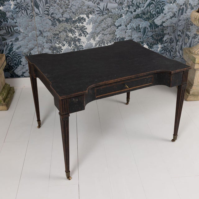 An exceptional Dutch writing desk from the Louis XVI period wearing aged black paint. Shaped top and sides with one...