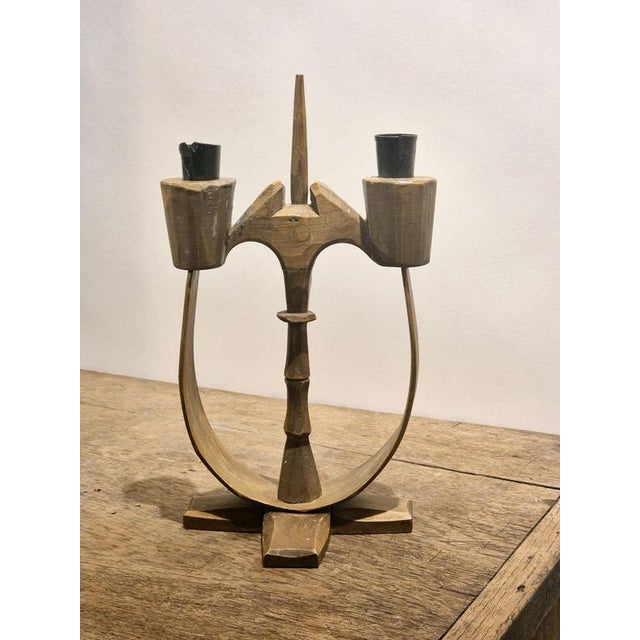 A traditional Taserud candelabra by Koppfeldt Arvika. In stained, hand cut wood and wrought iron candle holders. A history...