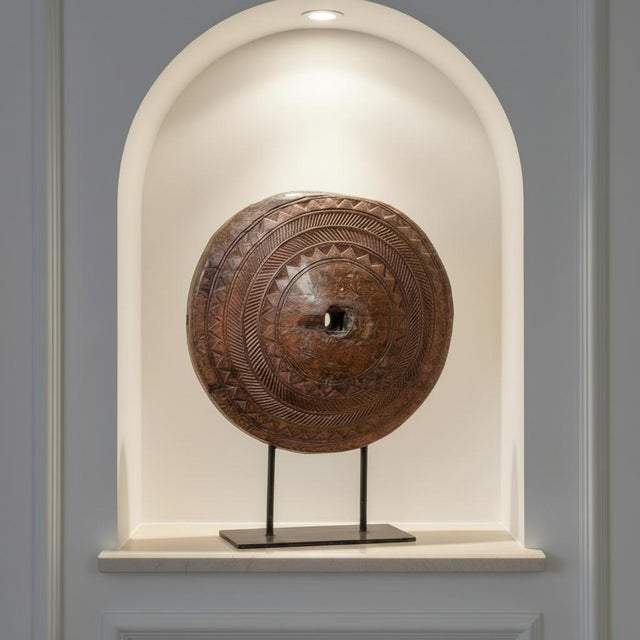 Dimensions: 32″ W x 10″ D x 40″ H Hand carved wheel from the 1800s is mounted on an iron stand. The wear is consistent of...