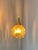 The yellow gold pendant light with glass and brass captivates with its drop-shaped design. The amber shade shines...