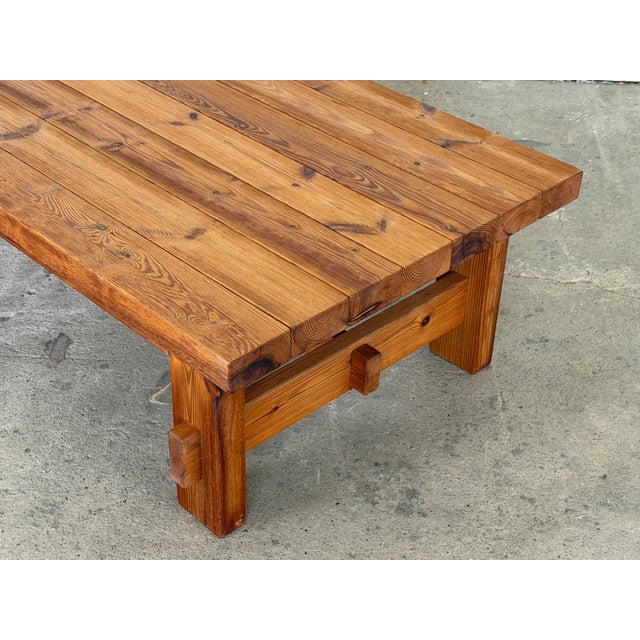 A solid pine plank-top coffee table by Hans Frydendal for Christian IV, Denmark, 1970s. The top is constructed from wide...