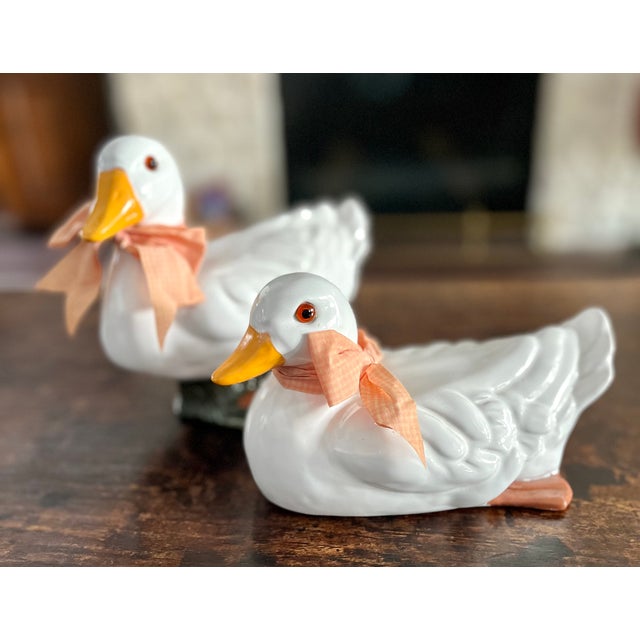 Created by Earth Needs Ltd. of Petaluma California in 1983. Terra cotta glazed ducks with glass eyes and ribbon bow...