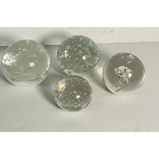 Set of 4 controlled bubbles clear glass paperweights.