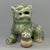 This is a handmade Chinese Longquan celadon ceramic lion ornament with delicate carved‑out details. Natural earth‑patina...