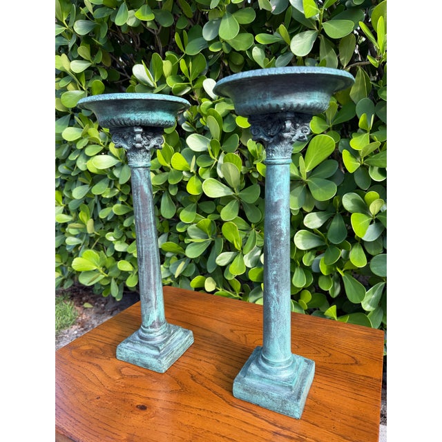 Striking pair of Maitland-Smith candleholders inspired by classical architectural columns. Finished in a richly layered...