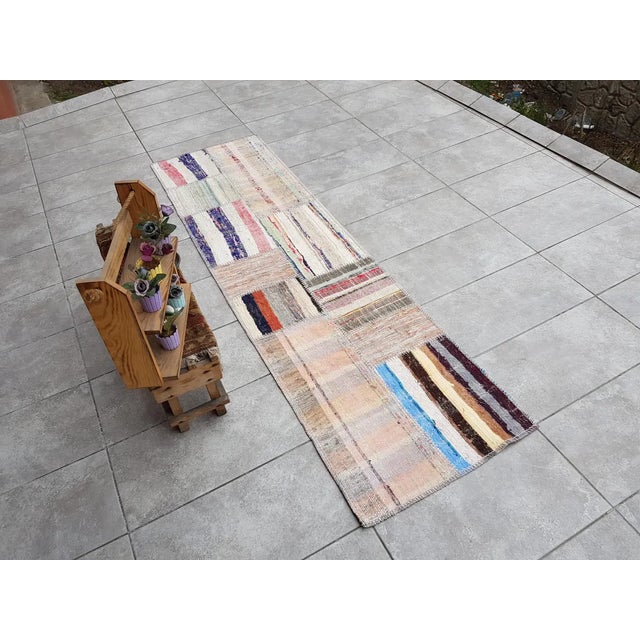 This is a vintage Turkish Oushak rug from the Mid 20th Century. The piece was hand-knotted.