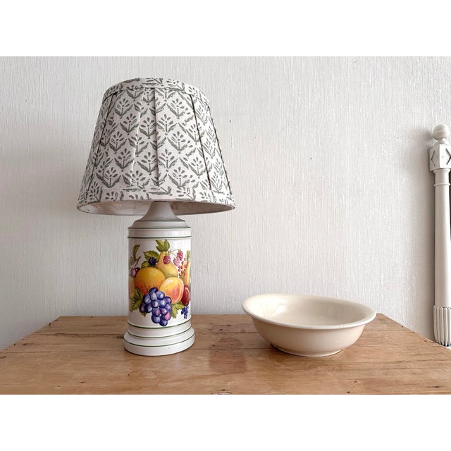 Sweet small vintage ceramic lamp with colorful fruit transferware on front Lamp has an off white background with dark...