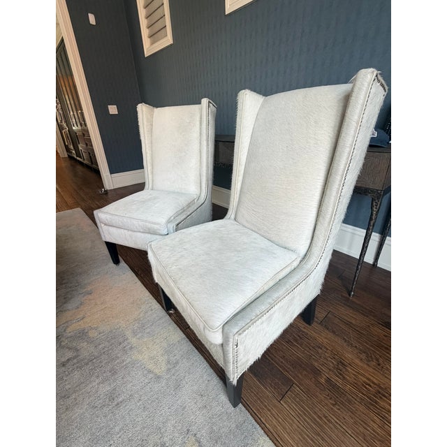 This striking pair of Serena & Lily wingback chairs is upholstered in genuine pony hair hide, transforming a classic...