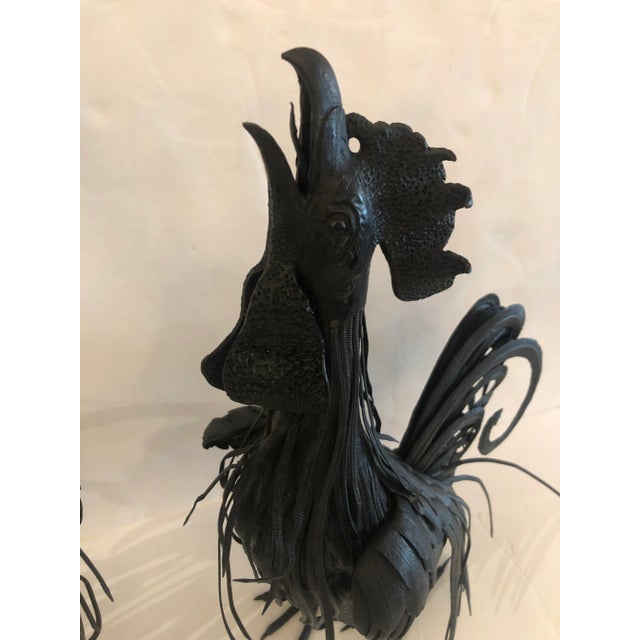 A fabulous pair of vintage hand forged black iron rooster sculptures having terrific details and crowing poses.