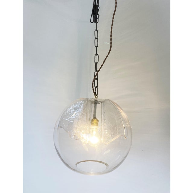 Vintage glass pendant light by peil and putzler. The lamp emits a beautiful light thanks to its carefully designed glass....