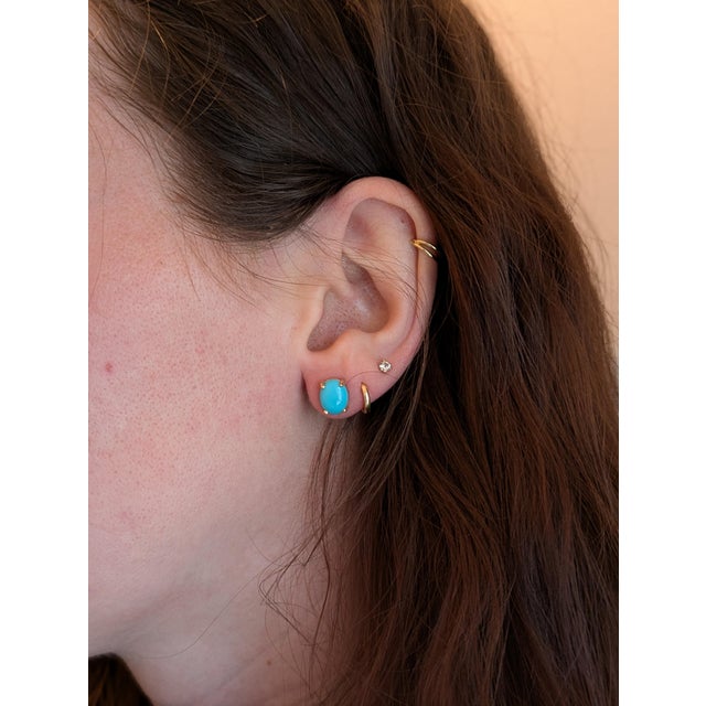 Who says statement pieces have to shout? These turquoise studs whisper elegance with their soft 8x6mm cabochons and sunny...