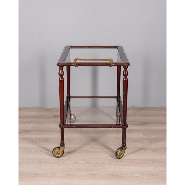 Food trolley with wooden structure and two transparent glass shelves, with gilded brass handle, Italian design, 1960s.