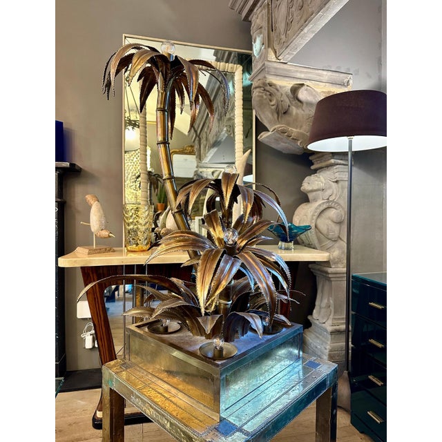 A 3 arm palm tree floor lamp by maison jansen in brass with large square base with 4 up lighters within. Could also be...