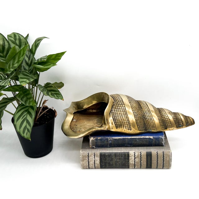 Large vintage brass wall pocket in the form of a spiral conch shell, made in Korea in the mid to late 20th century. The...