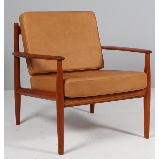 Grete Jalk lounge chair in teak. New upholstered cushions with full grain aniline leather. Made by France & Daverkosen....