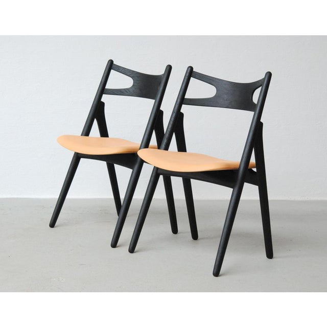 1950´s set of two fully restored Hans Wegner "Sawbuck" chairs in ebonized oak. The "Sawbuck chair" was designed by Hans J....