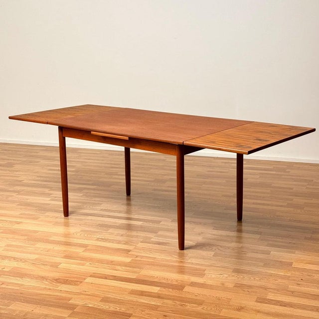 The dining table was made in Denmark in the 1950s-60s. It is made of teak veneer on the top and in solid teak wood in the...