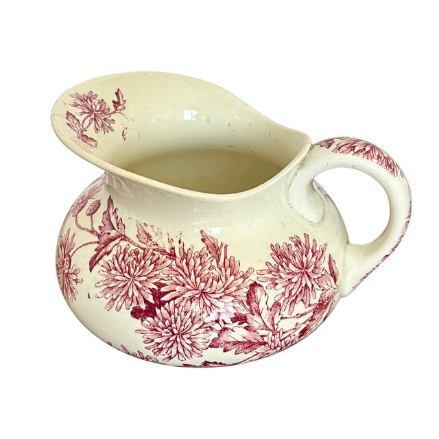 this exquisite antique pitcher was made by the renowned french manufacturer longwy around 1900. crafted in fine faience,...